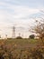 Electricity pylons row of far distance field farm agriculture