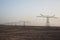 Electricity pylons in sand desert