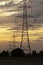 Electricity pylons at sunset in a row