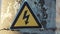 Electricity safety sign on the pole next to the transformer. yellow sign lightning danger high voltage concept