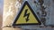 Electricity safety sign on the pole next to the transformer. yellow sign lightning danger high voltage concept