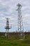 Electricity transmission pylons against cloudy sky