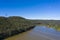 An electricity transmission tower and cables across a river in regional Australia