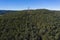 An electricity transmission tower and cables across a river in regional Australia