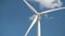 Electricity wind generator on bright cloudy sky background - wind energy and technology concept