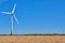 Electricity Wind turbines in a field of wheat.