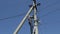 Electricity work, man repairs electric pole wearing all the safety equipment