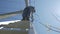 Electricity work, man repairs electric pole wearing all the safety equipment