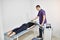 Electromagnetic therapy of the back. Physiotherapist doctor uses medical equipment for highly effective pain treatment and