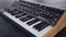 Electronic analog synthesizer closeup on dark background
