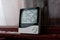 Electronic clock, calendar, thermometer, and hygrometer, against the background of condensation on glass, high humidity. Digital