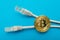 Electronic crypto currency bitcoin and internet connectors are isolated on a blue background