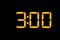 Electronic digital clock with yellow numbers on a black background shows the time three zero hours of the night. Isolate, close-up