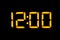 Electronic digital clock with yellow numbers on a black background shows the time Twelve zero zero o`clock of the day. Isolate,