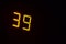 Electronic digital scoreboards. Digital LCD Stopwatch Timer. Orange luminous numbers on a black background