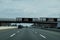 Electronic information sign over a busy multi-lane highway that says Coronavirus stay home to stop the spread.