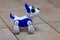 Electronic interactive toy dog puppy on a beige ceramic floor background of selective focus. High technology concept, pet of the f