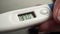 Electronic medical thermometer in beautiful woman hands. 2 close up videos in 1