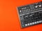 Electronic musical instrument or audio mixer or sound equalizer on a orange background analog modular synthesizer