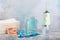 Electronic oral irrigator, toothbrush, paste, dental floss and mouthwash on background.