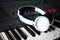 Electronic piano with white headphones close-up. music devices