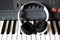 Electronic piano with white headphones close-up. music devices top view