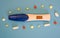 Electronic pregnancy test surrounded by multi-colored pills of various shapes on a blue background