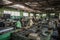 electronic recycling facility, with workers sorting and dismantling e-waste