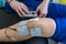 Electronic therapy on knee used to treat pain.