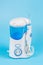 Electronic Tooth Irrigator for personal home usage on blue background