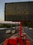 Electronic traffic sign stating Expect Delays with traffic blurred at rush hour
