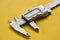 Electronic vernier caliper, yellow background