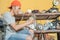 Electronics repairman installs a blender bowl against the backdrop of a shelf of damaged goods