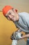 An electronics repairman smiles at the camera while opening a faulty fan