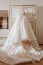 Elegance Fashion Wedding Dress Hanging in Bedroom