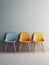 Elegance meets simplicity in this minimalist studio shoot of a beautifully designed room with three colorful chairs.