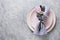 Elegance spring table setting with pink tulip on grey. Easter dinner. Top view