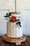 Elegant 2 tier wedding cake with edible floral arrangement. Cake