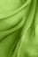 Elegant abstract background with diagonal waves of  green  fabric folds