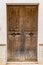 Elegant antique brown wood entrance door, close-up