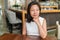 Elegant Asian middle-aged businesswoman pensive portrait. Beautiful mature Chinese business woman relaxing in restaurant