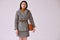 Elegant asian woman in fashionable woolen coat and classic skirt