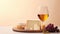 Elegant assortment of various cheeses paired with a glass of white wine on a warm background