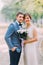 Elegant attractive bride and groom posing outdoors in the park. Newlyweds portrait shot