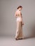 Elegant backless moscato dress. Beautiful ivory silk evening gown. Studio portrait of young ginger woman. Transformer dress idea f