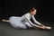 Elegant ballerina did a stretch. photo shoots in the studio on a dark background