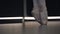 Elegant ballerina moving feet together and standing up on tiptoes. Close-up of ballet dancer`s feet in pointes. Grace