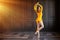 Elegant ballerina in pointe shoes dances with bouquet of tulips