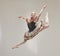 Elegant ballet dancer dancing with a vintage style, jumping and performing in a studio. Portrait of a skilled, talented