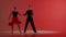 Elegant Ballroom Dance Couple on Spotlight red background.